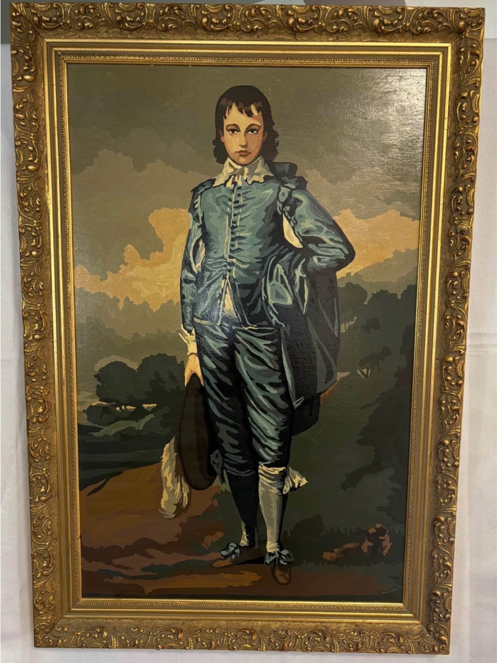 Thomas Gainsborough’s iconic “Blue Boy” ornately framed. 31-3/4” h x 21-3/4 “ w.